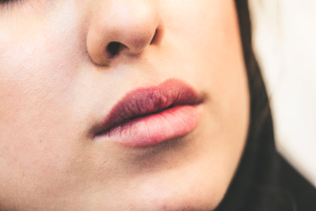 womans face with red lipstick