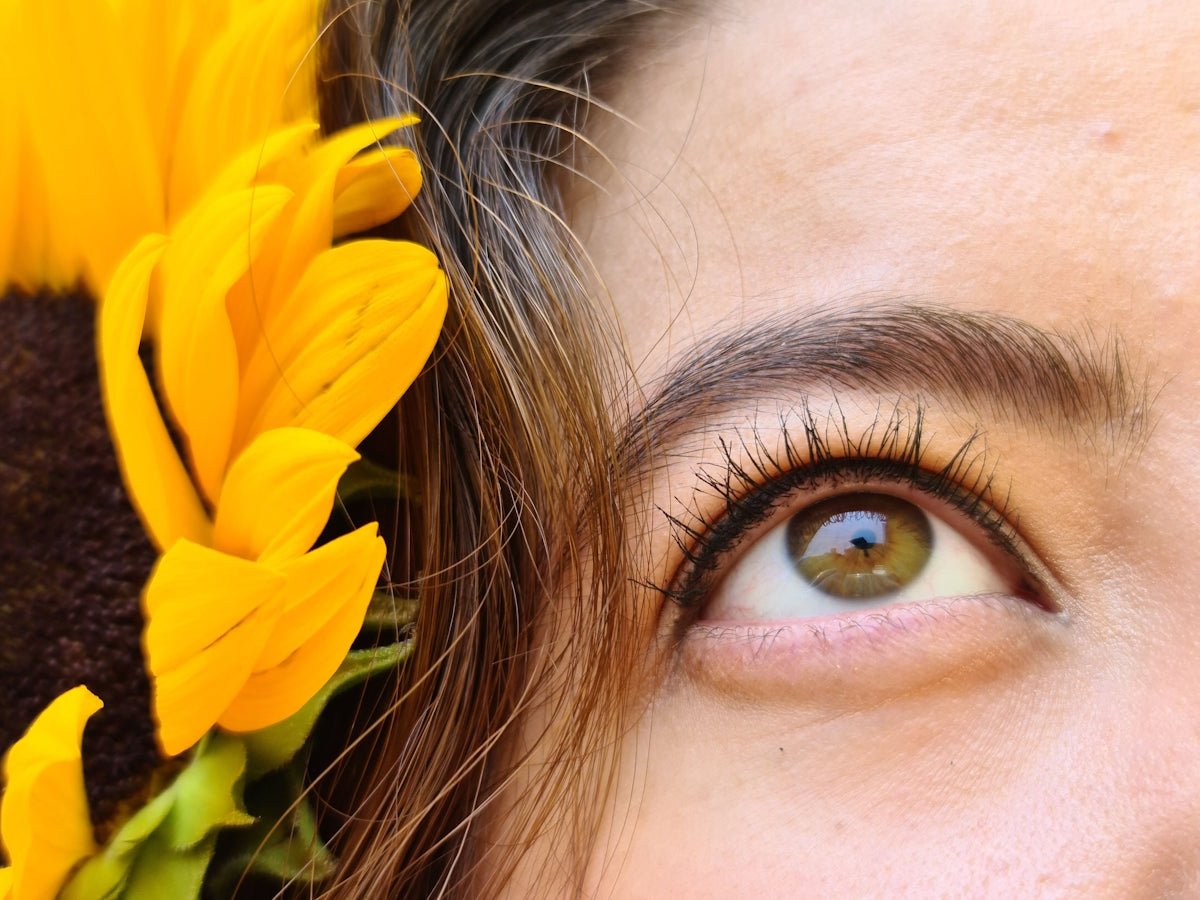 a close up of a person with a sunflower