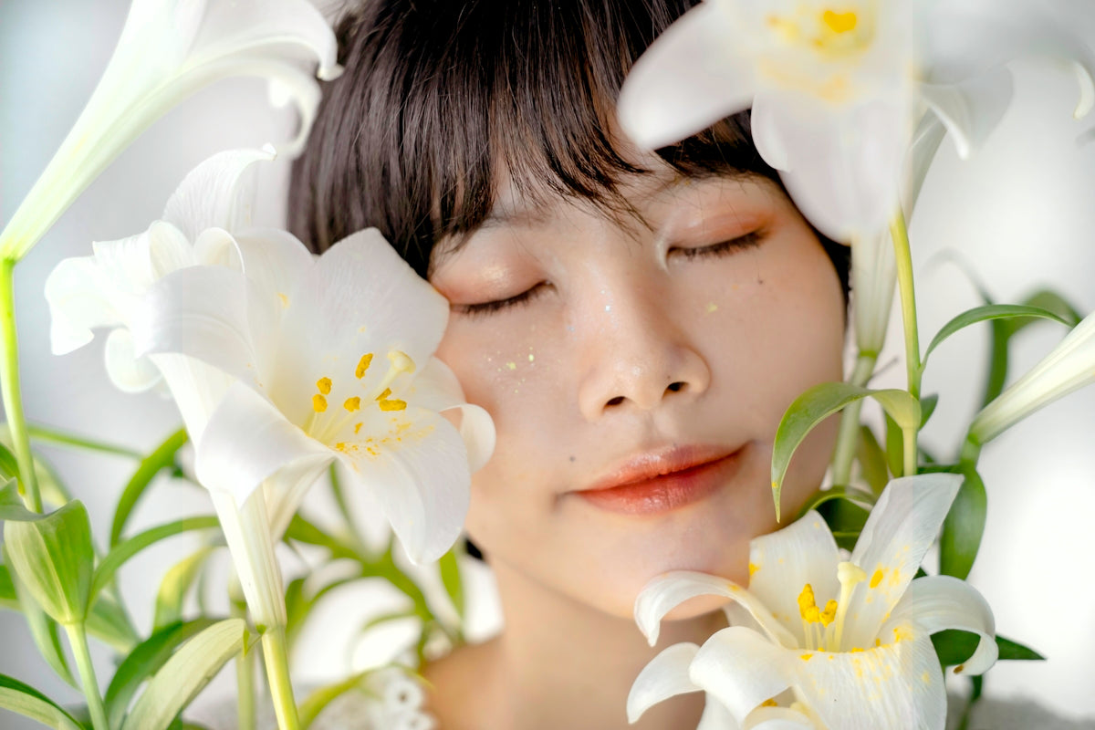 a woman with her eyes closed and flowers in her hair
