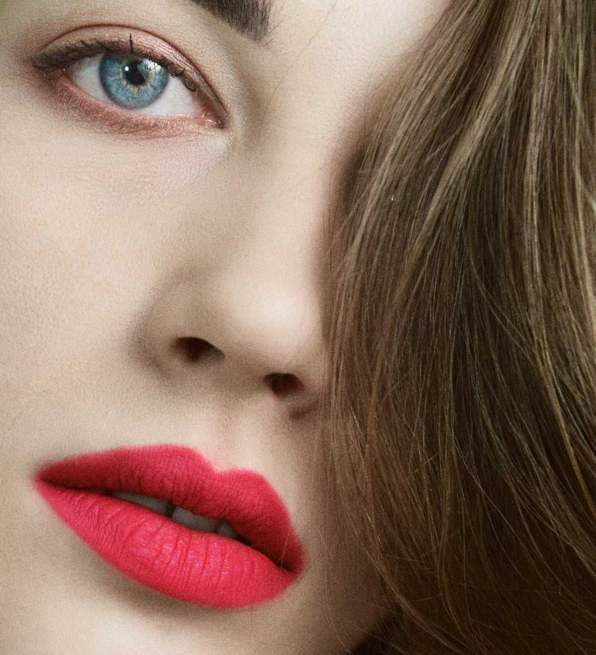 a close up of a woman's face with bright red lipstick