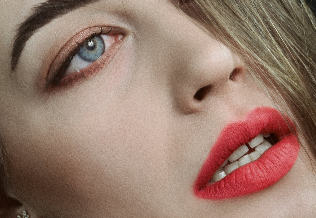 a close up of a woman with red lipstick