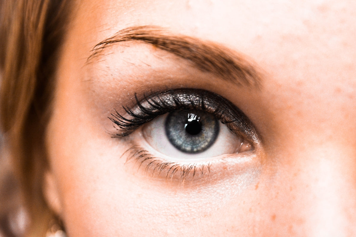 a close up of a woman's blue eye