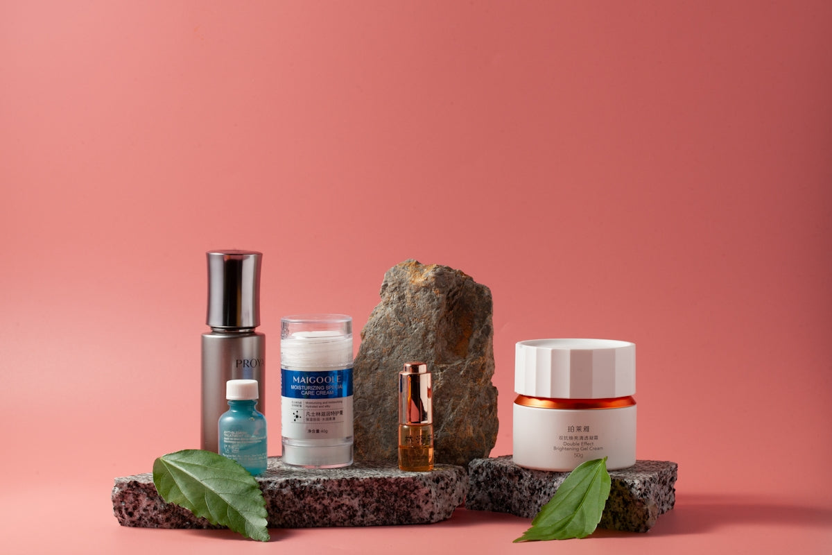 An assortment of skin care products on a pink background