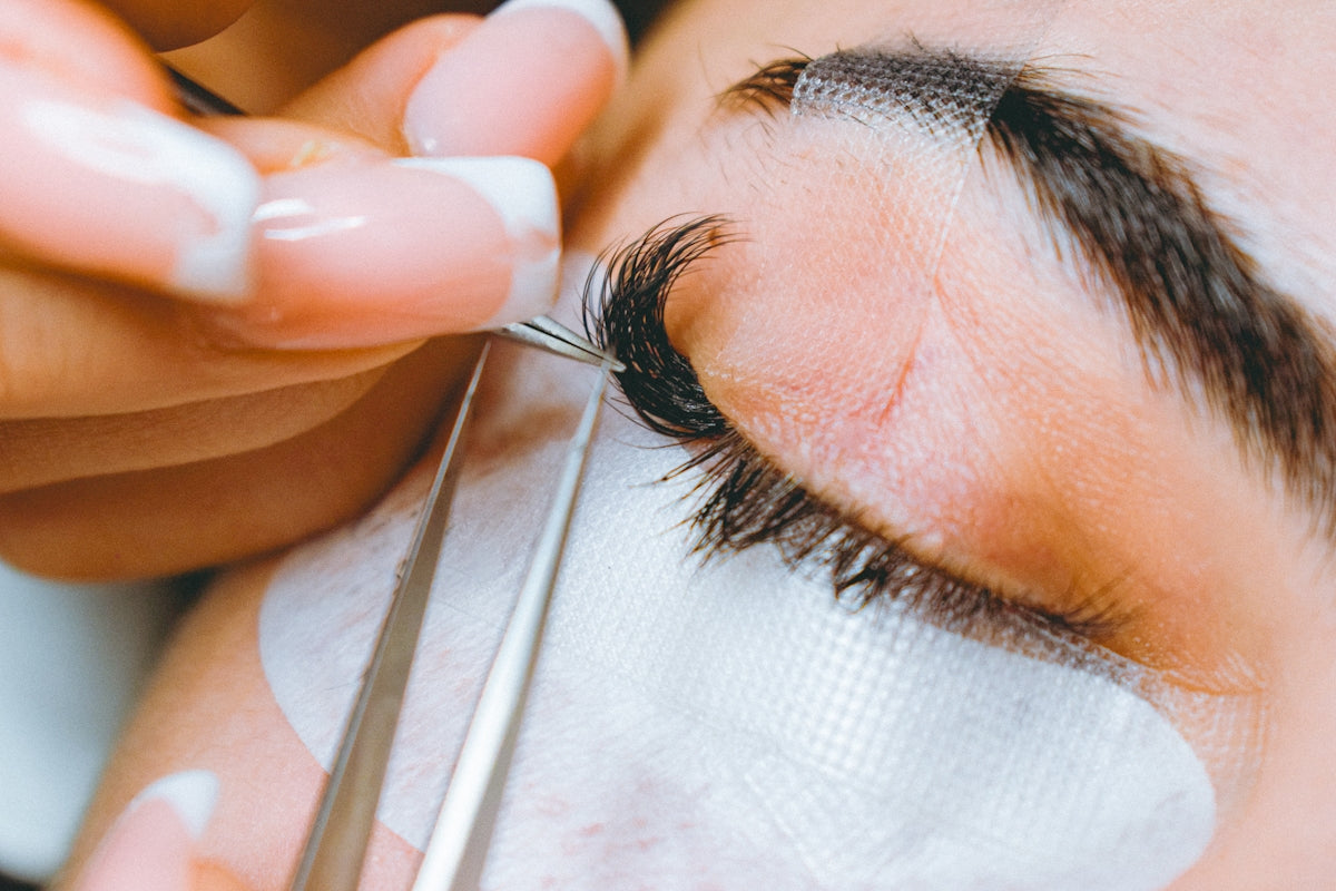 A close up of a person cutting a persons eye