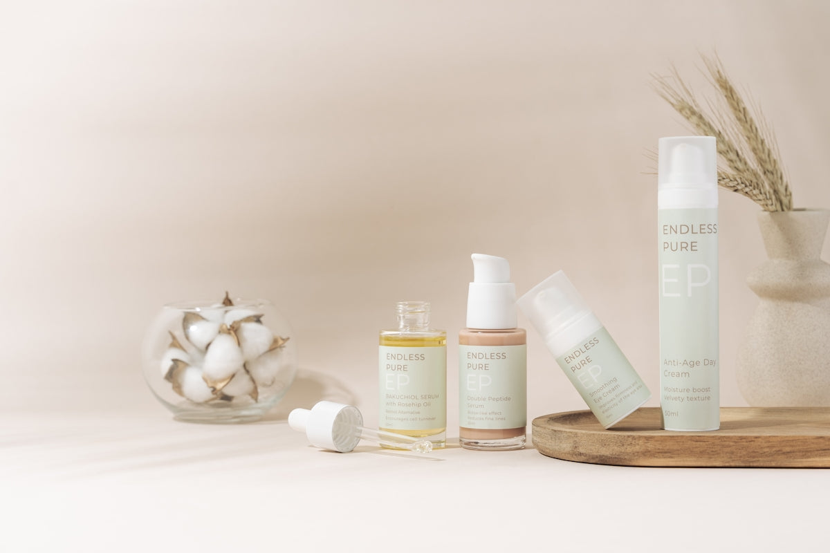 A table topped with bottles and containers filled with skin care products