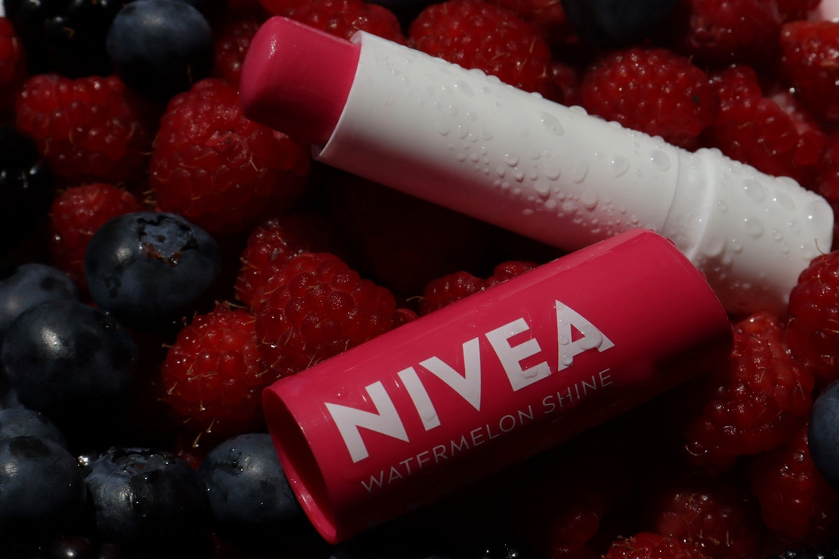 Nivea lip balm is shown with berries.