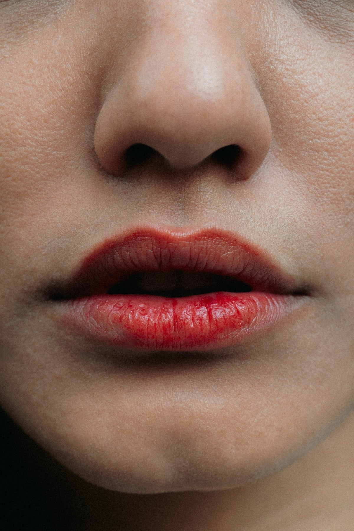 Close-up of a woman's red lips and nose