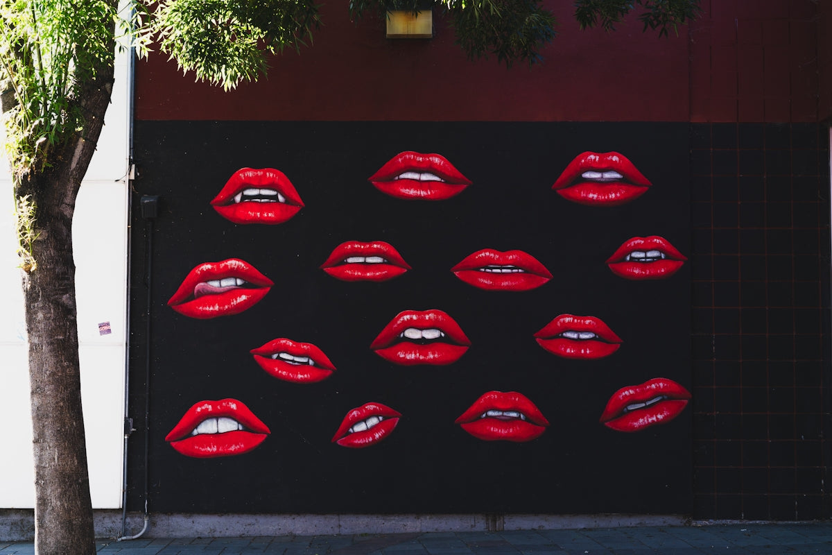 Red lips mural on a dark wall