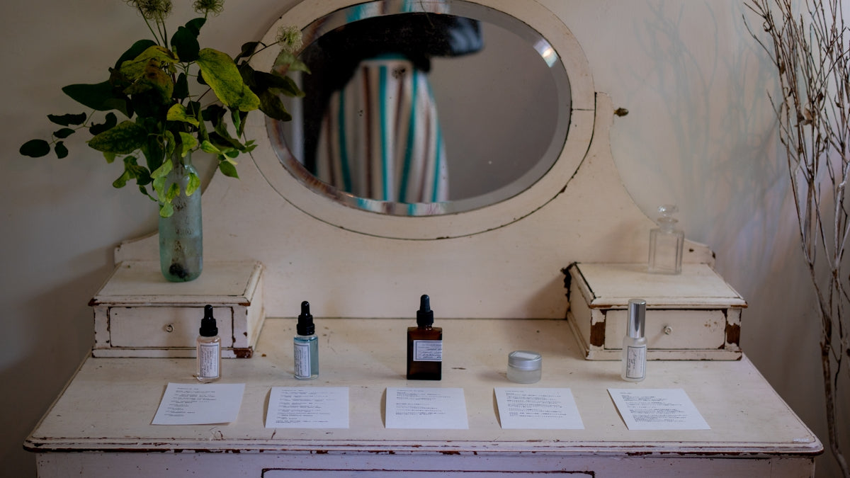 Vintage vanity with skincare products and flowers.