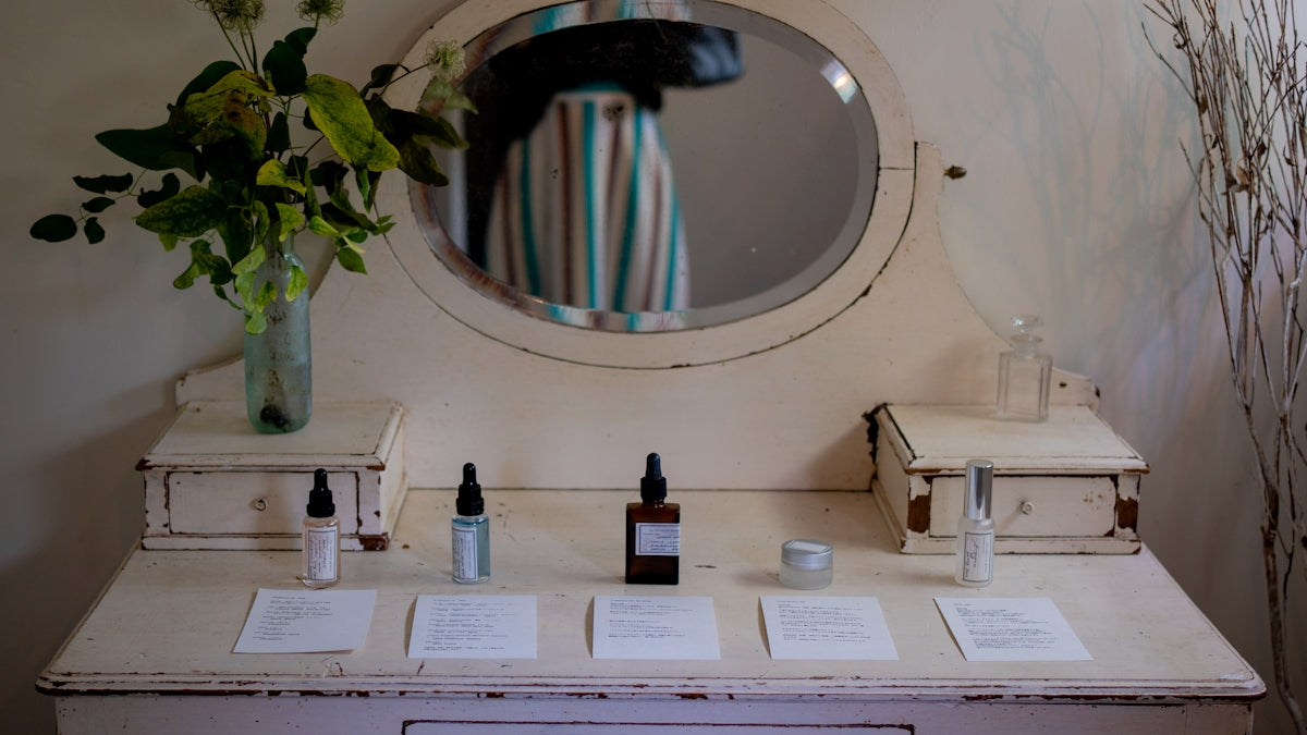 Vintage vanity with skincare products and flowers.