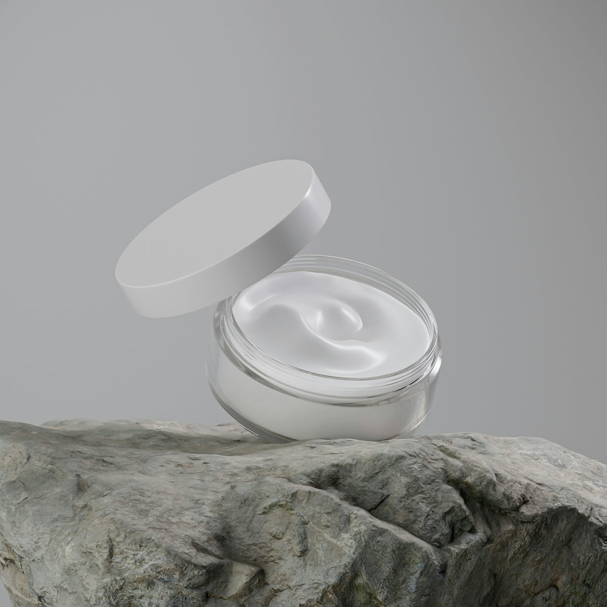 A jar of white cream on a rock