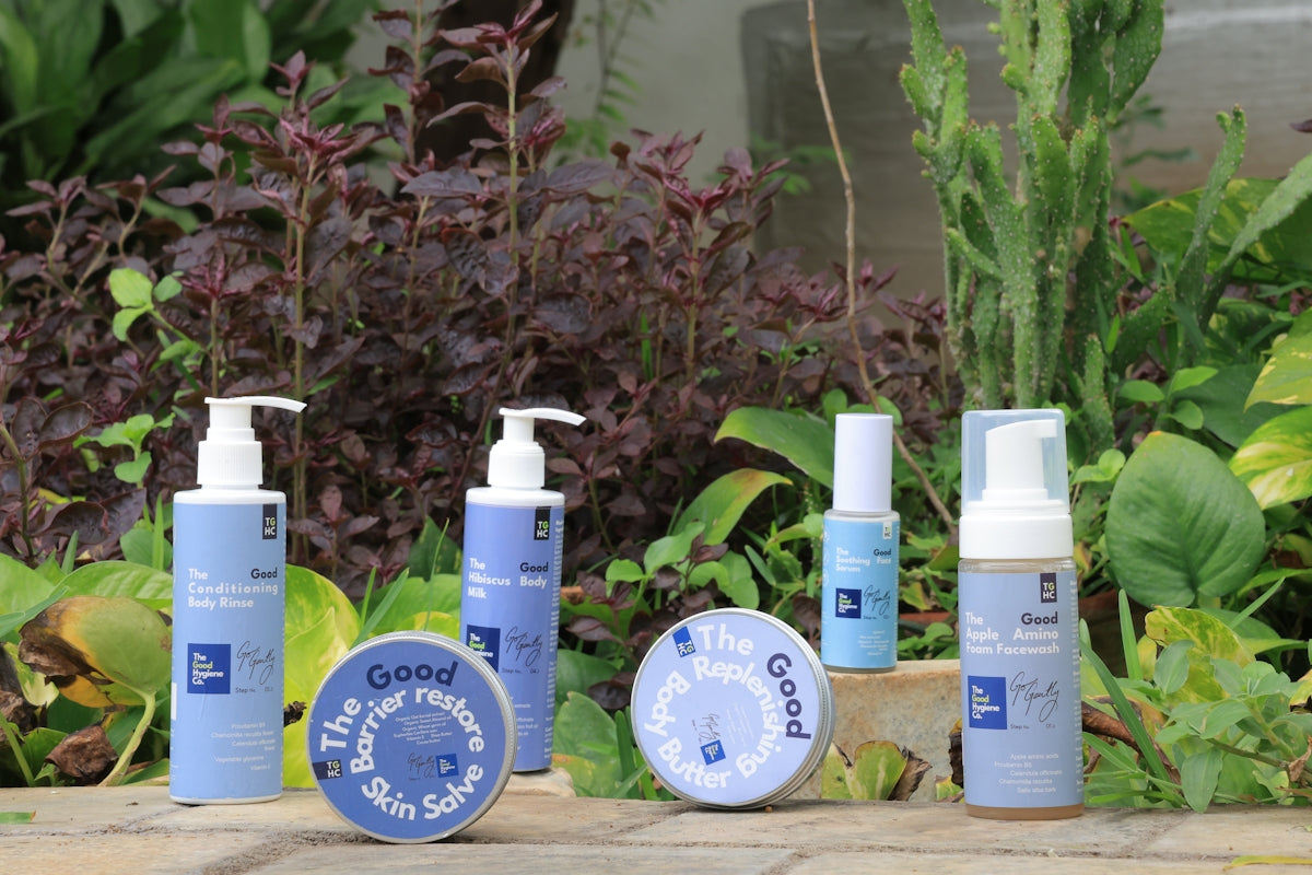 Skincare products displayed outdoors with lush greenery