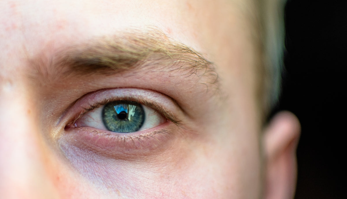 persons blue eyes in close up photography