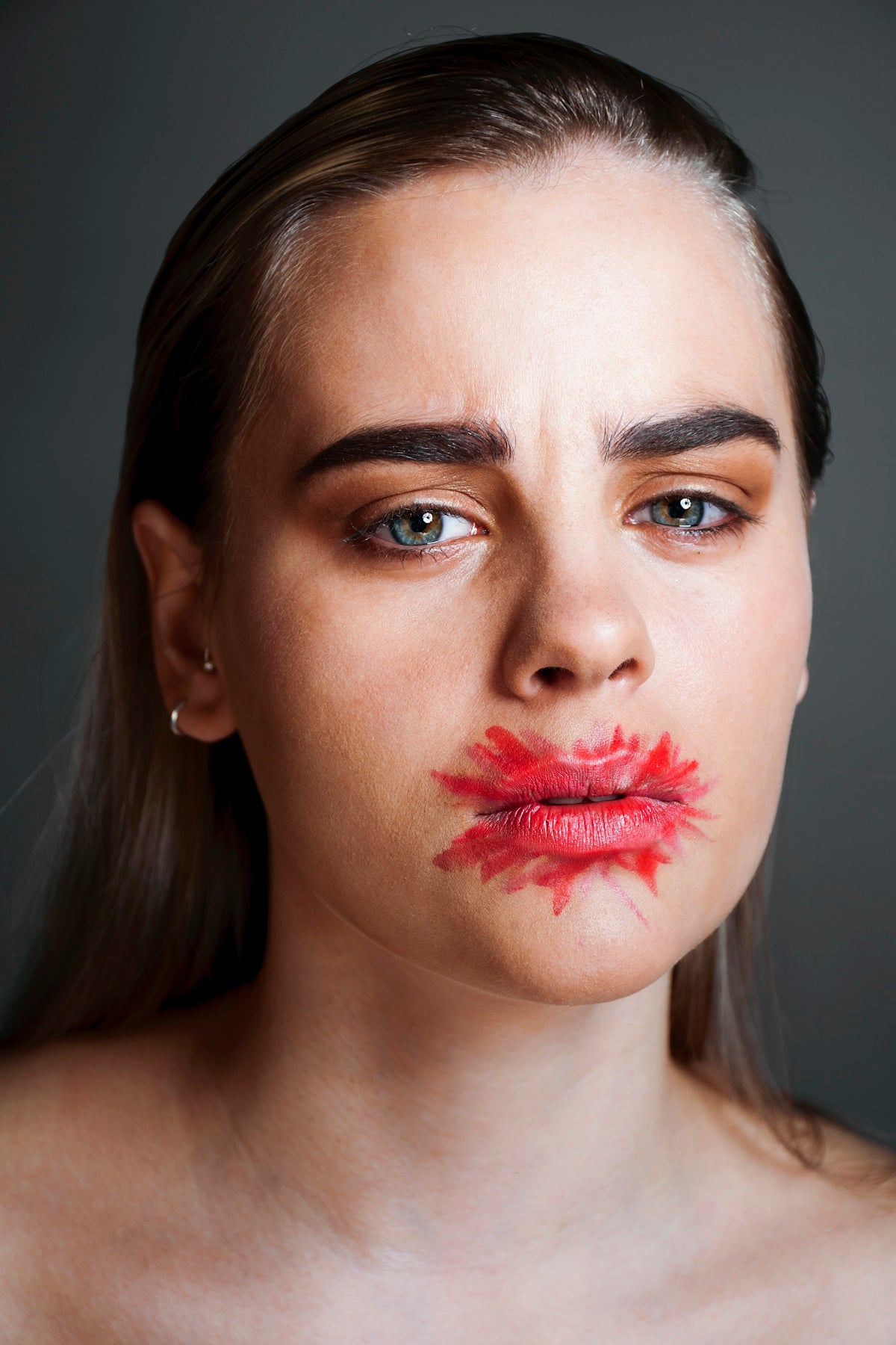 a woman with red lipstick on her face