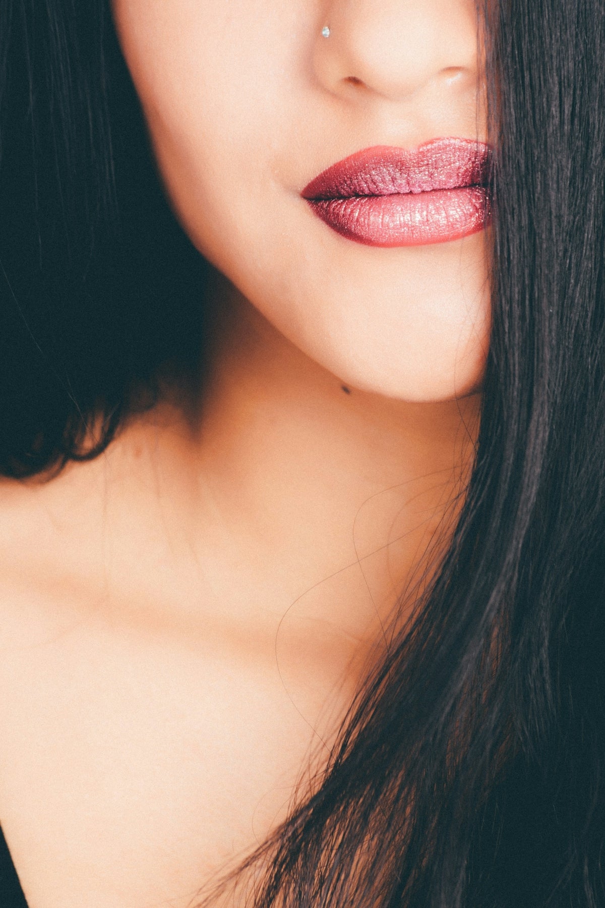 a close up of a woman with long black hair