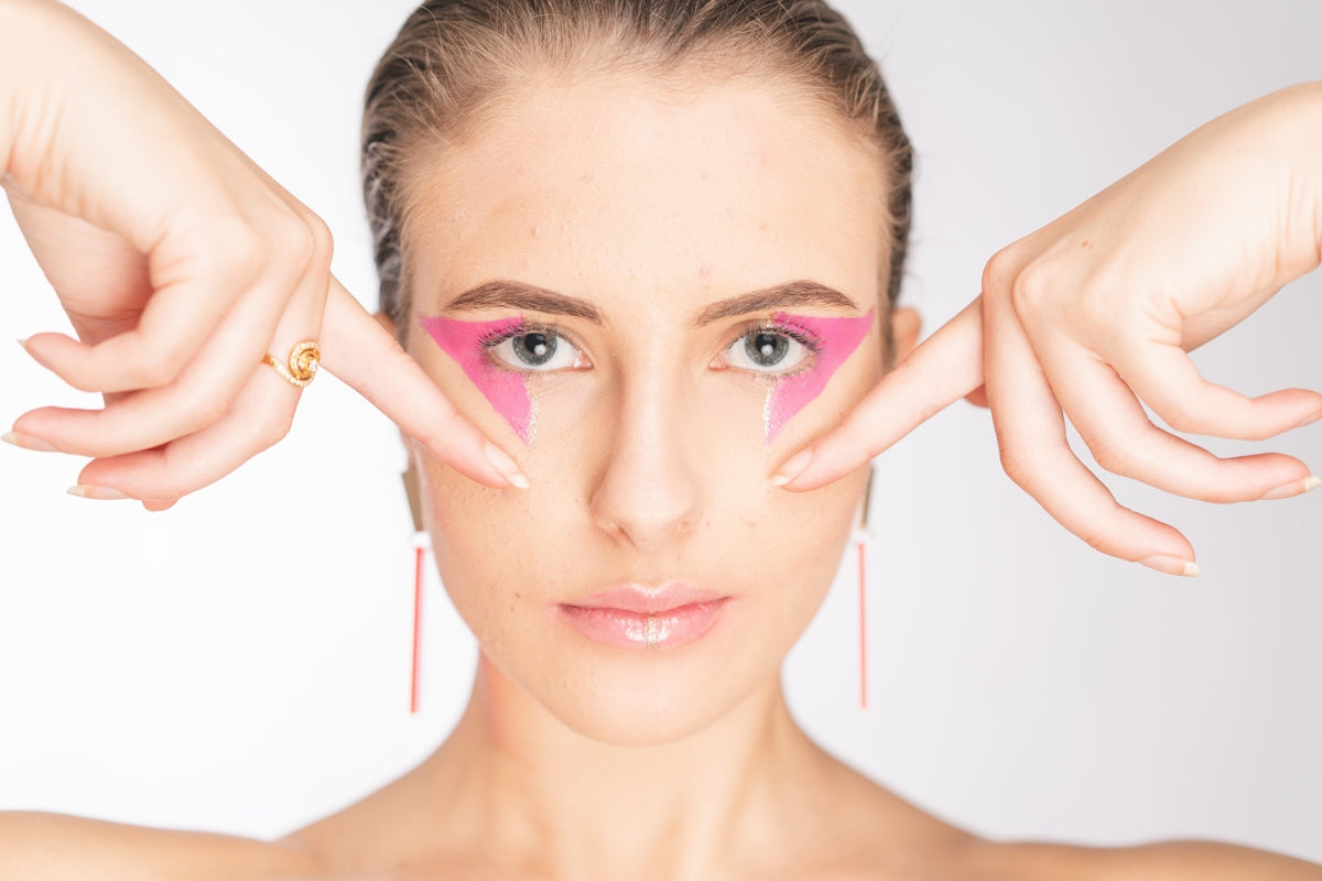 a woman with a pink triangle on her face