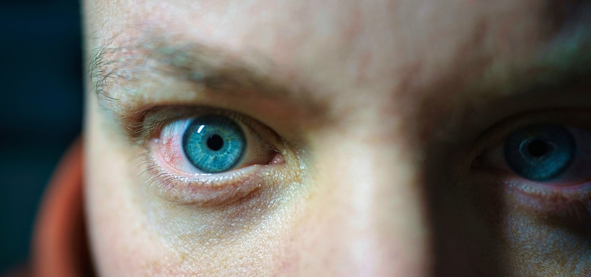 a close up of a person with blue eyes