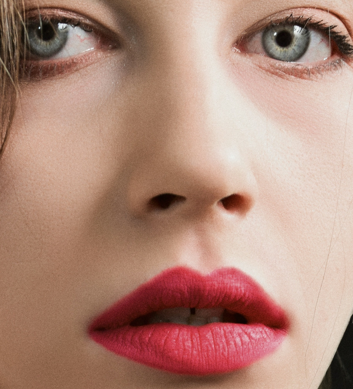 a close up of a woman's face with red lipstick