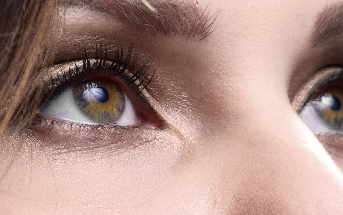 a close up of a woman's blue eyes