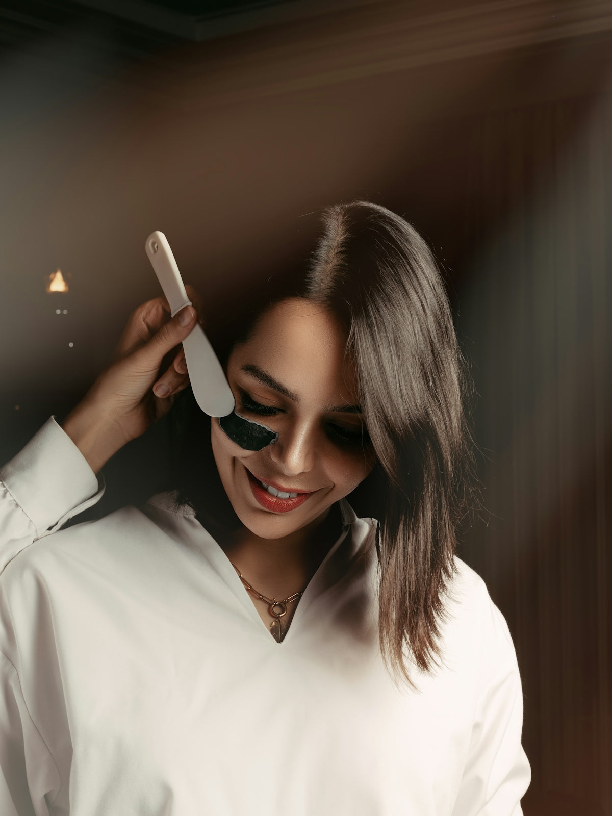 a woman holding a hair brush in her right hand