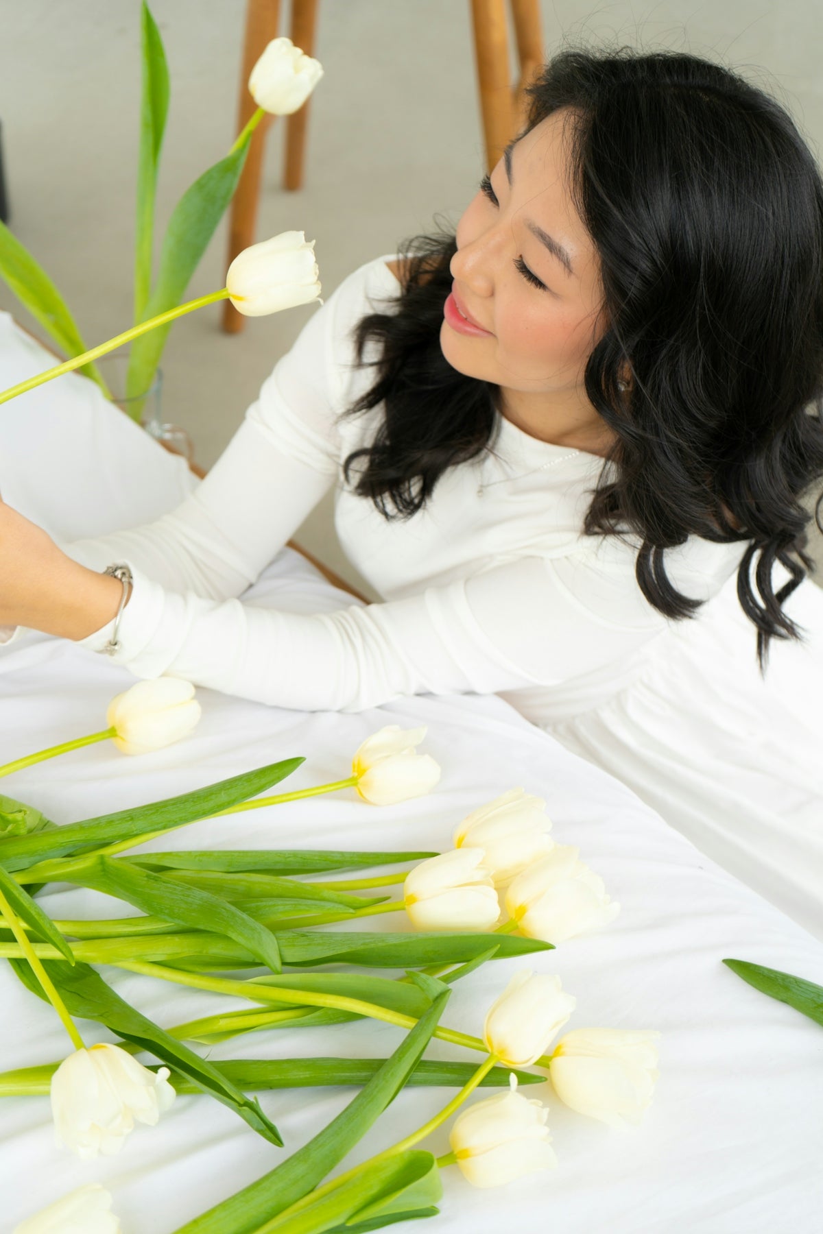 a woman is arranging flowers on a table