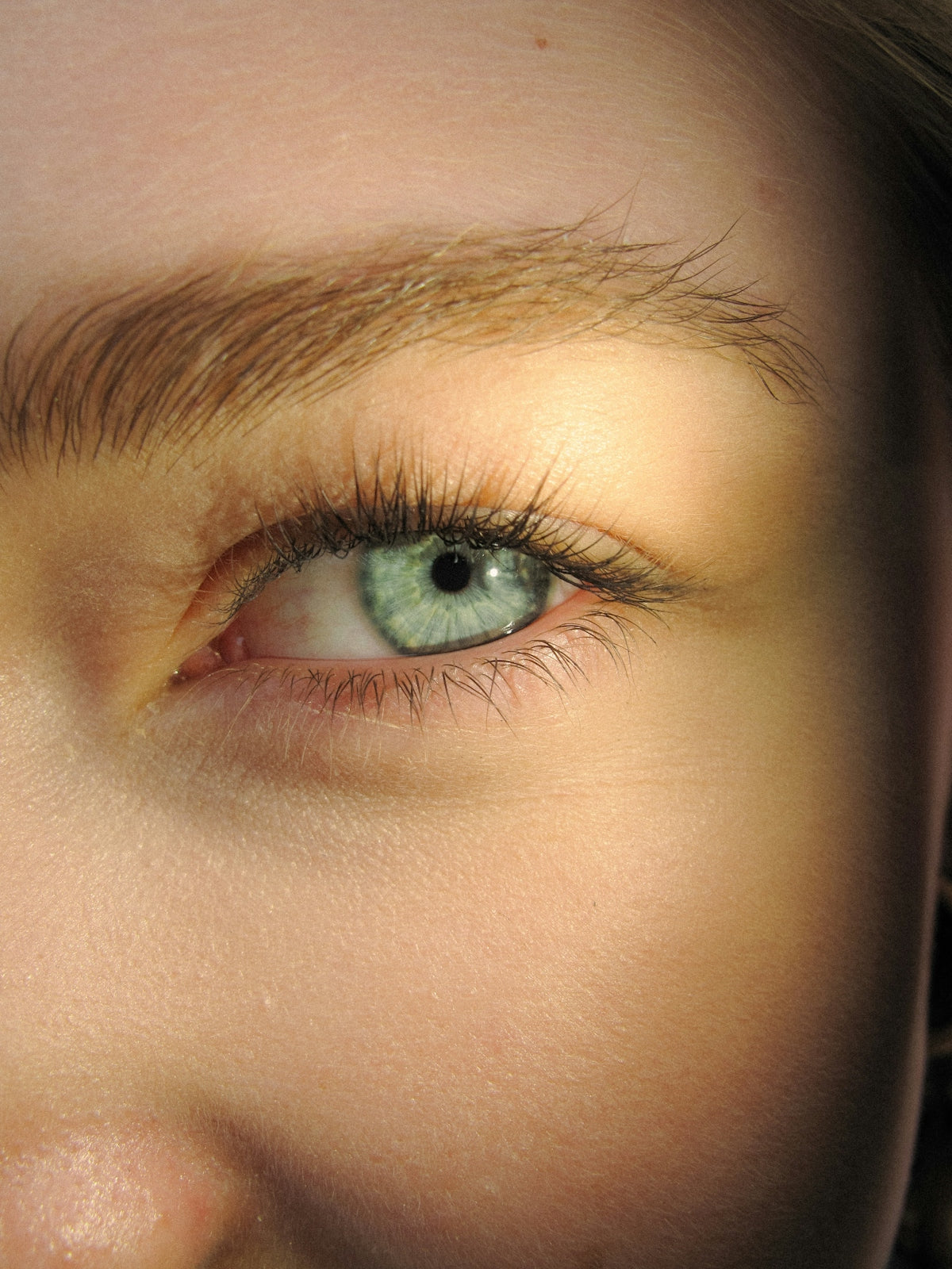 A close up of a woman's face with blue eyes