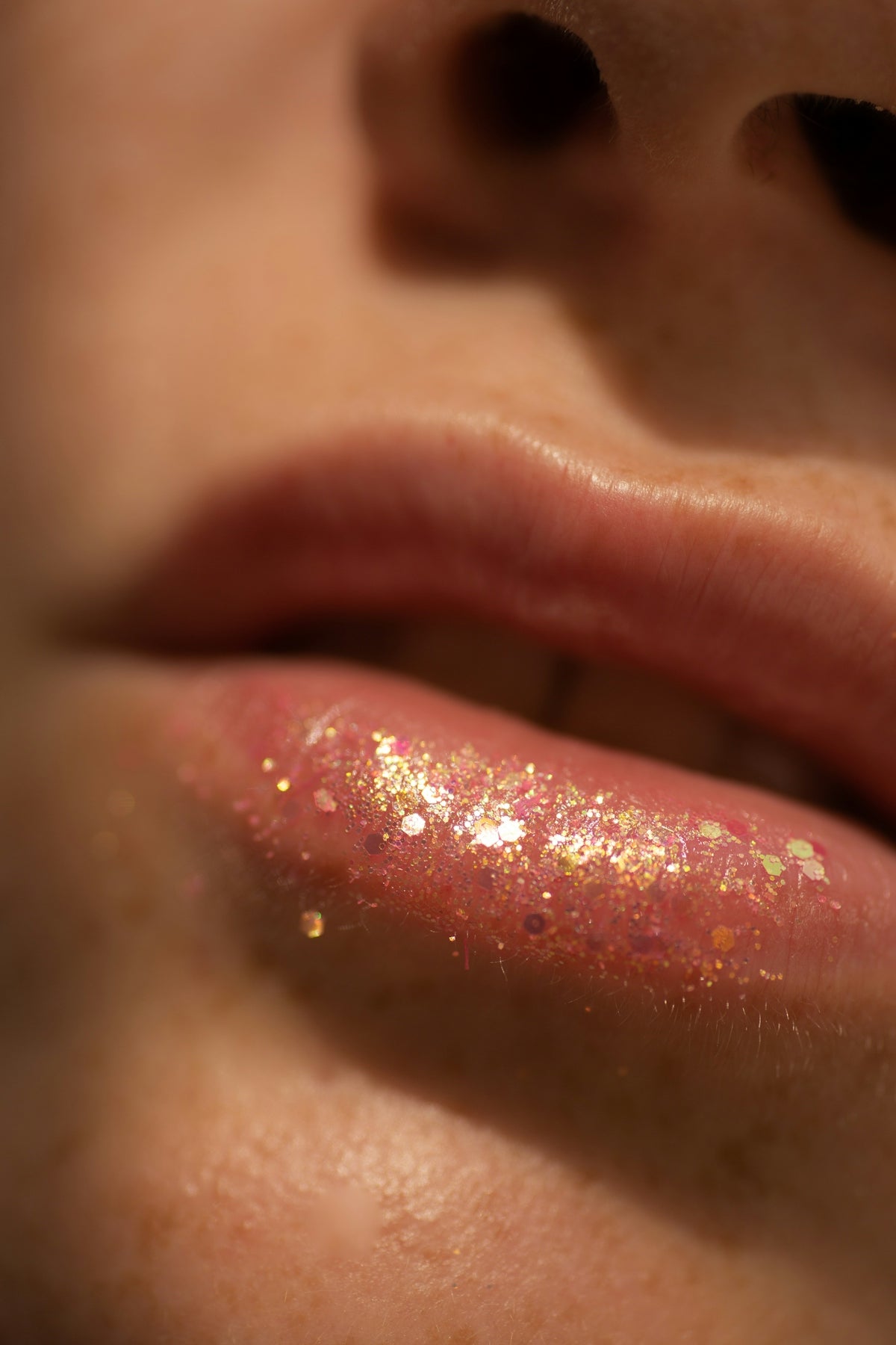 Close-up of a person's lips with glittery lip gloss.