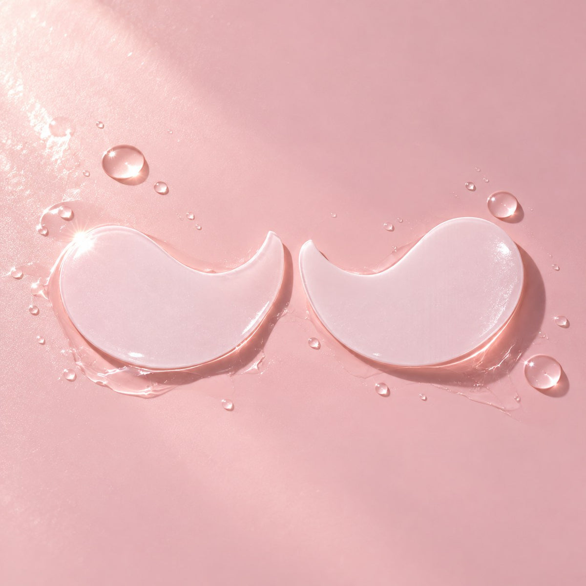 A pair of pale pink Brightening & Depuffing hydrogel eye masks