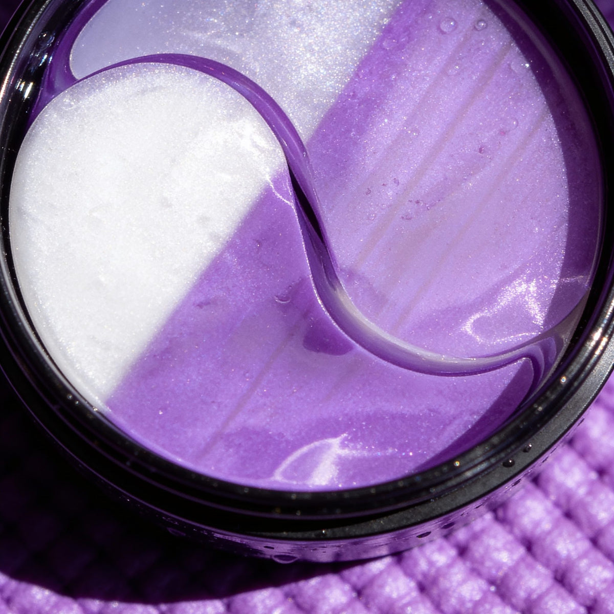 Close-up of purple Collagen Boost eye masks in the jar
