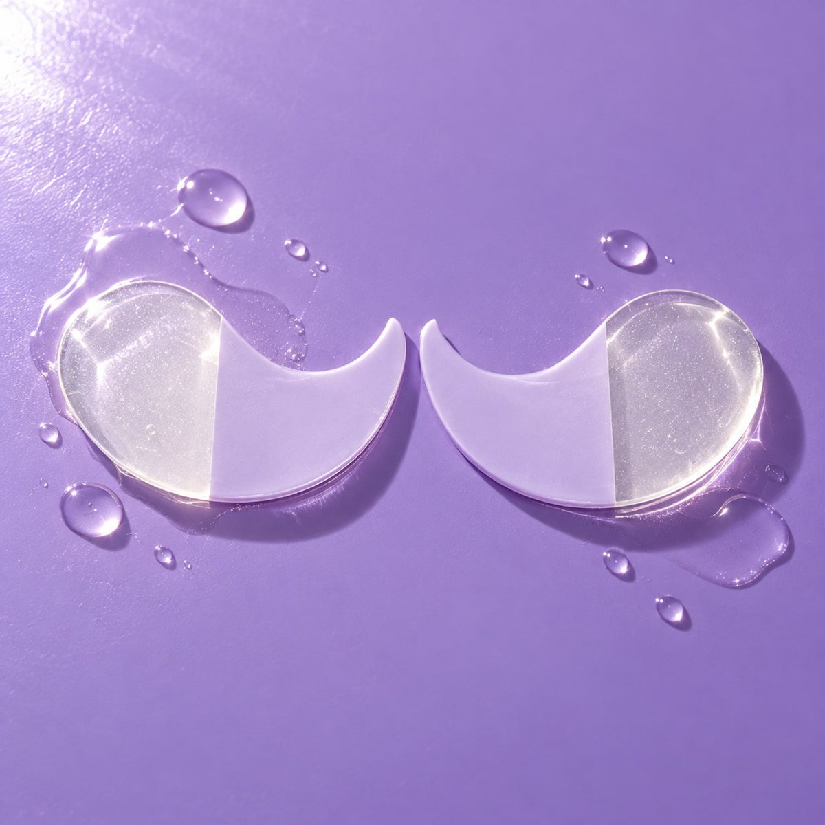 A pair of half-lilac, half-clear Collagen Boost hydrogel eye masks